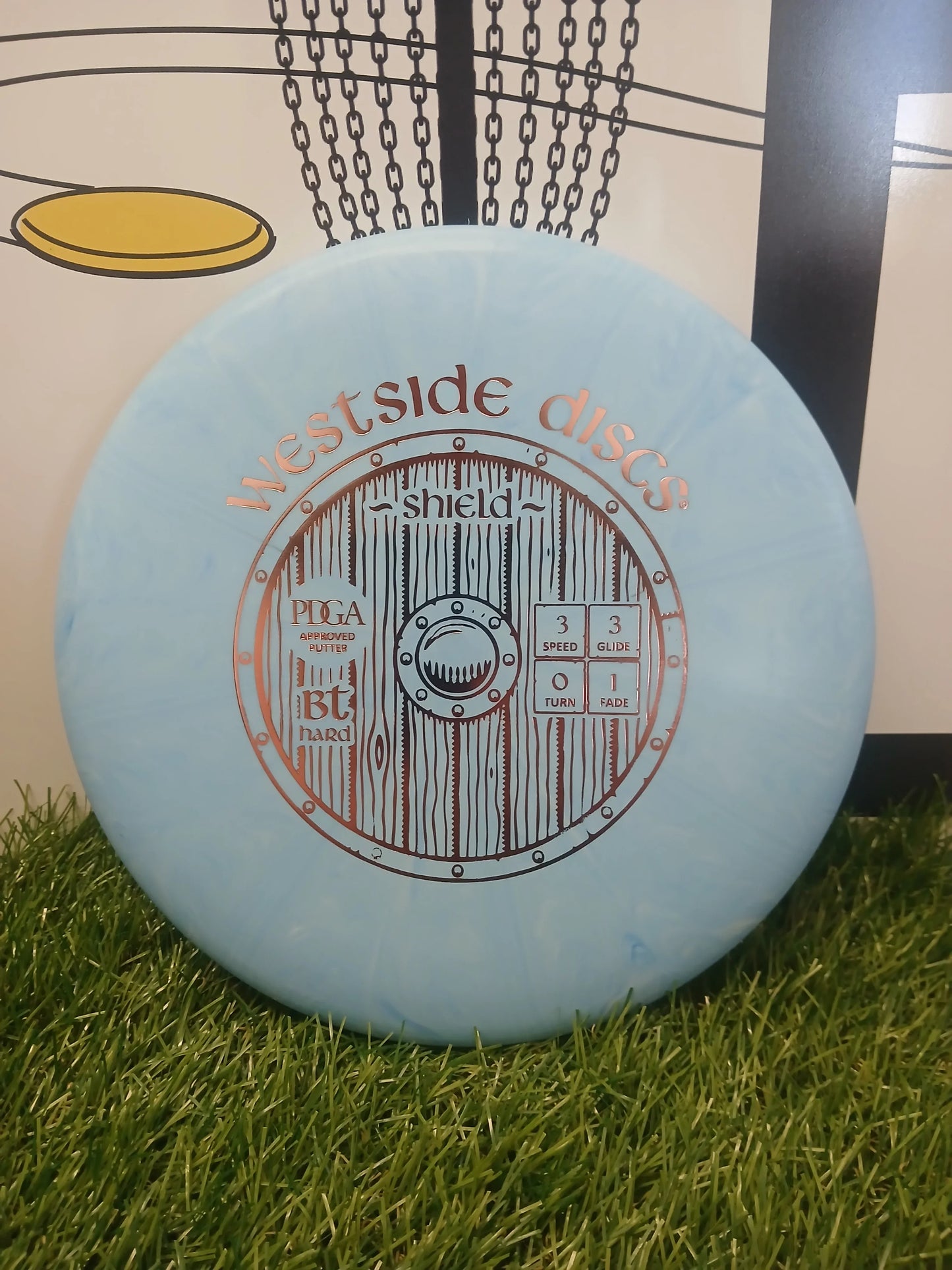 Westside Discs Shield BT Hard putter disc on grass, PDGA approved for disc golf