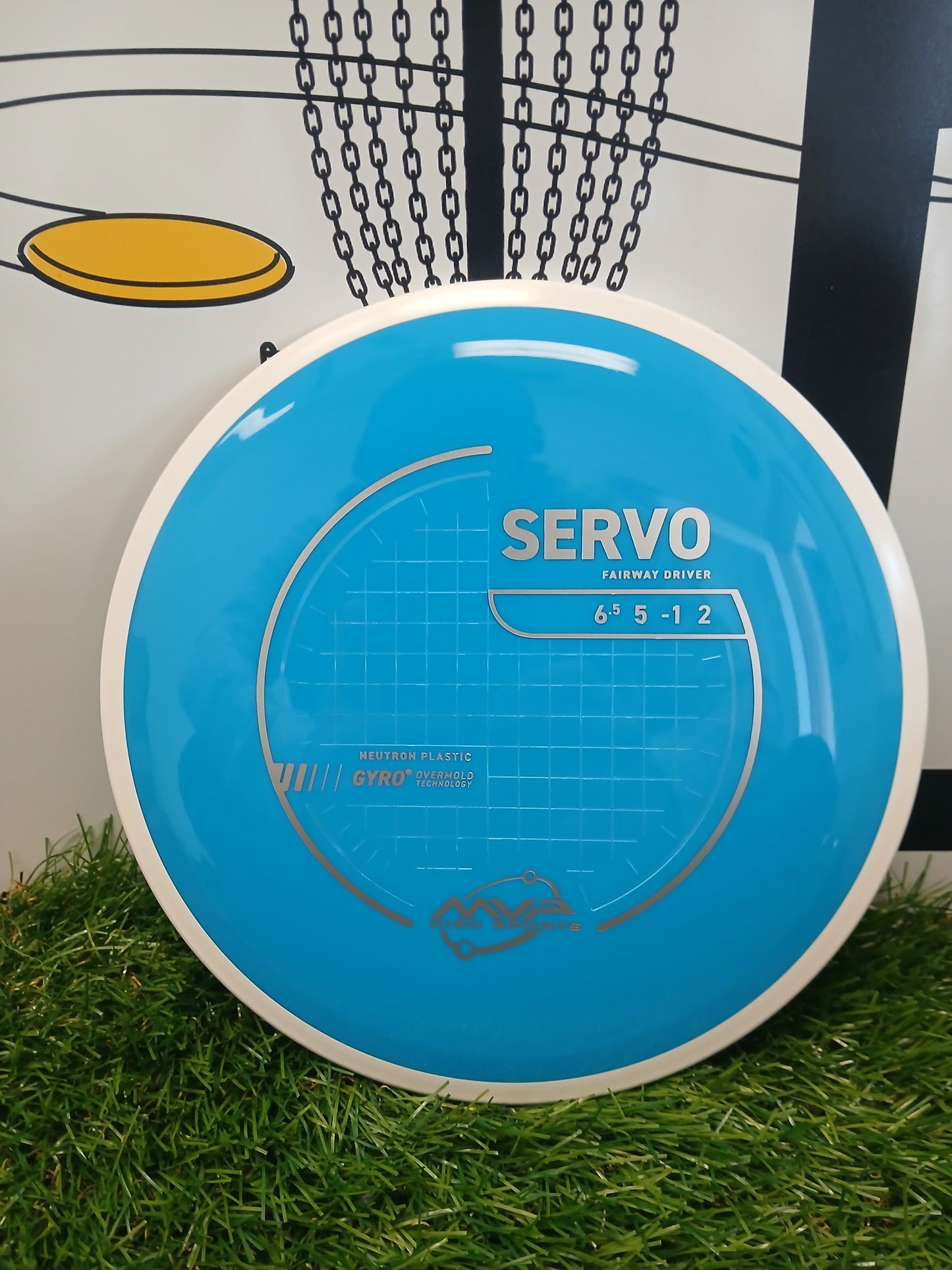 Blue MVP Disc Sports Servo fairway driver disc on grass, featuring Neutron plastic and Gyro technology for disc golf.