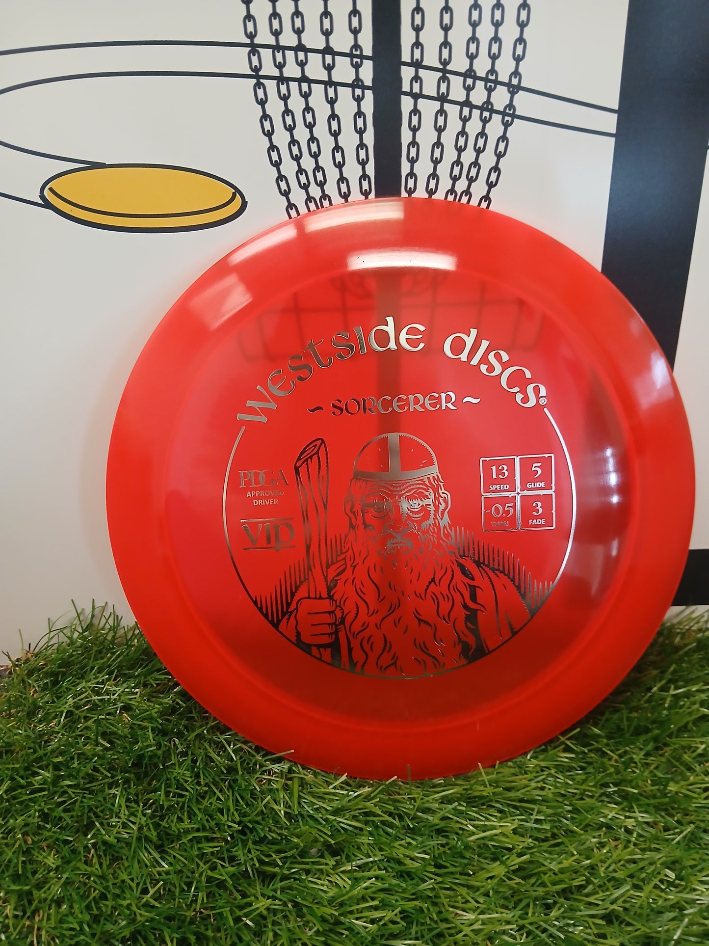 Westside Discs Sorcerer VIP disc golf driver on grass, PDGA approved with speed 13, glide 5, turn -0.5, fade 3