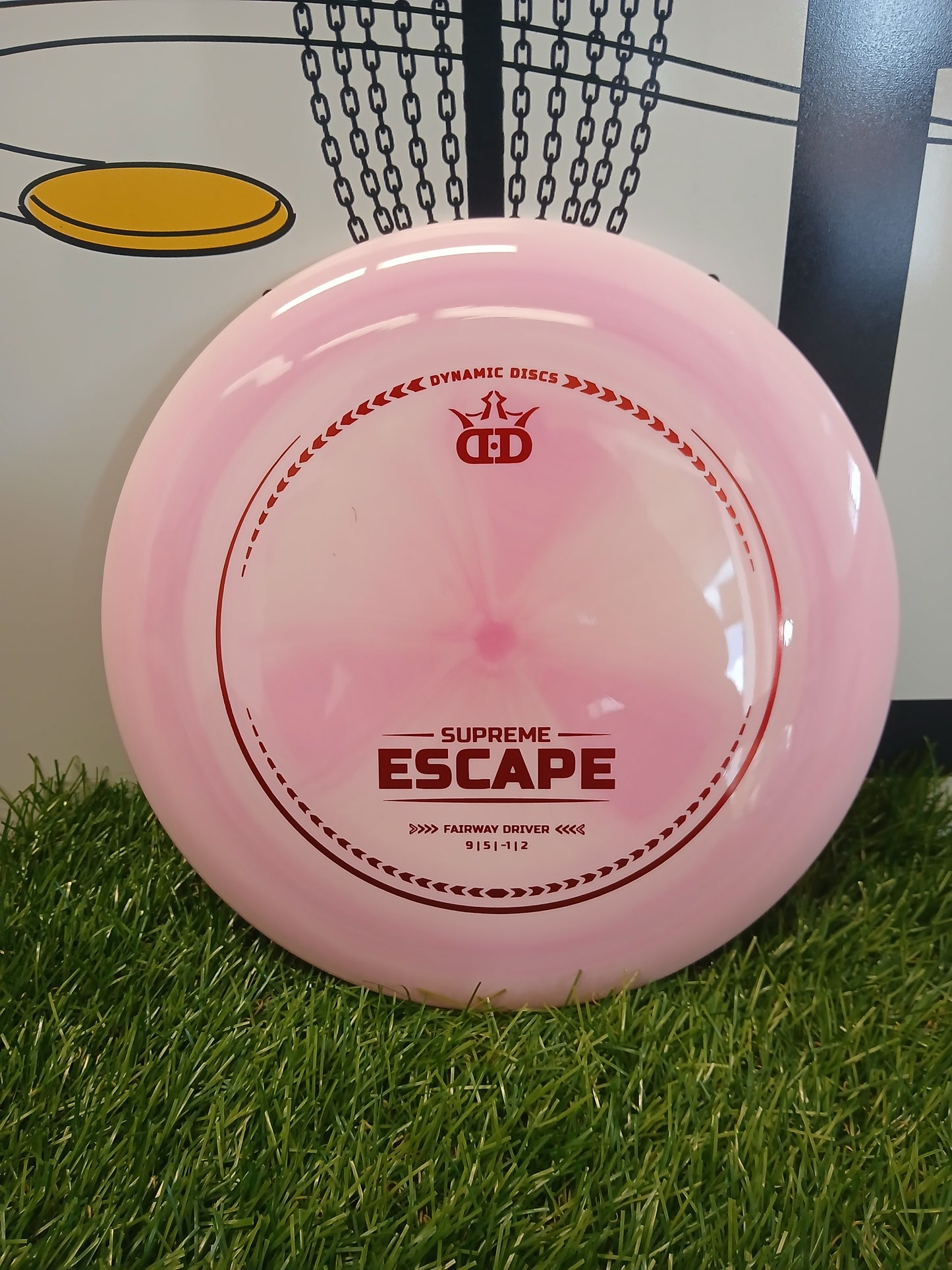 Pink Dynamic Discs Supreme Escape fairway driver disc golf disc on grass