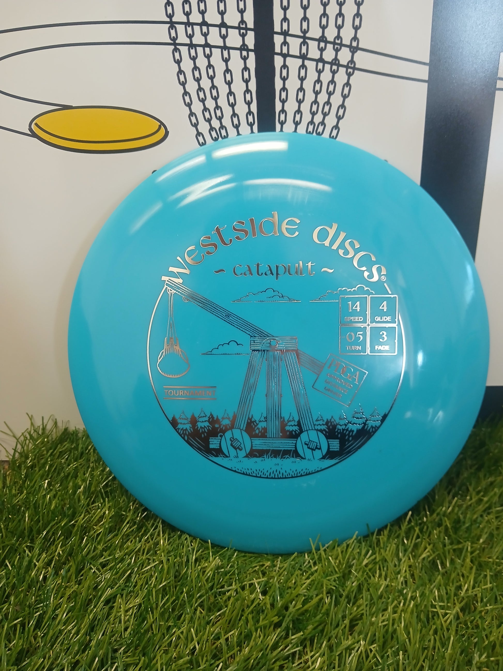 Westside Discs Catapult disc golf driver on grass, tournament approved with flight numbers 14/4/-0.5/3