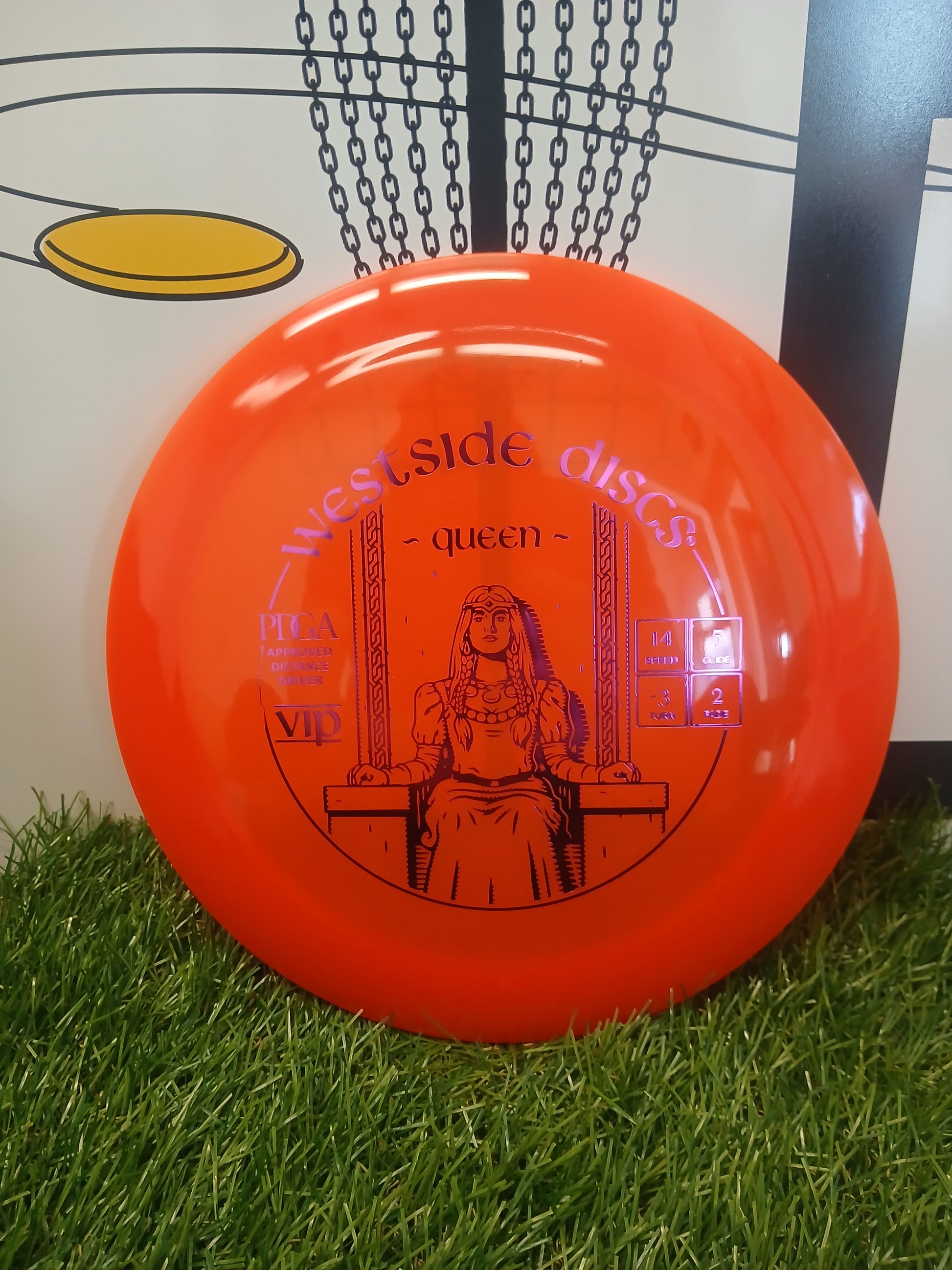 Vibrant orange Westside Discs Queen VIP distance driver on grass, PDGA approved for disc golf