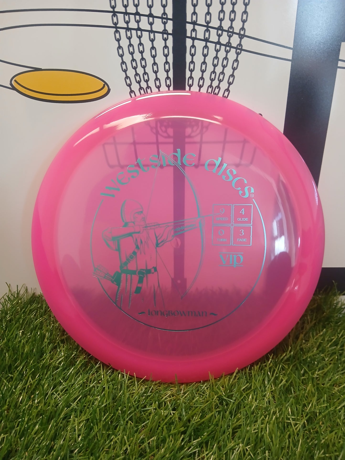 Pink Westside Discs Longbowman VIP disc golf disc on grass, featuring archer design and flight numbers