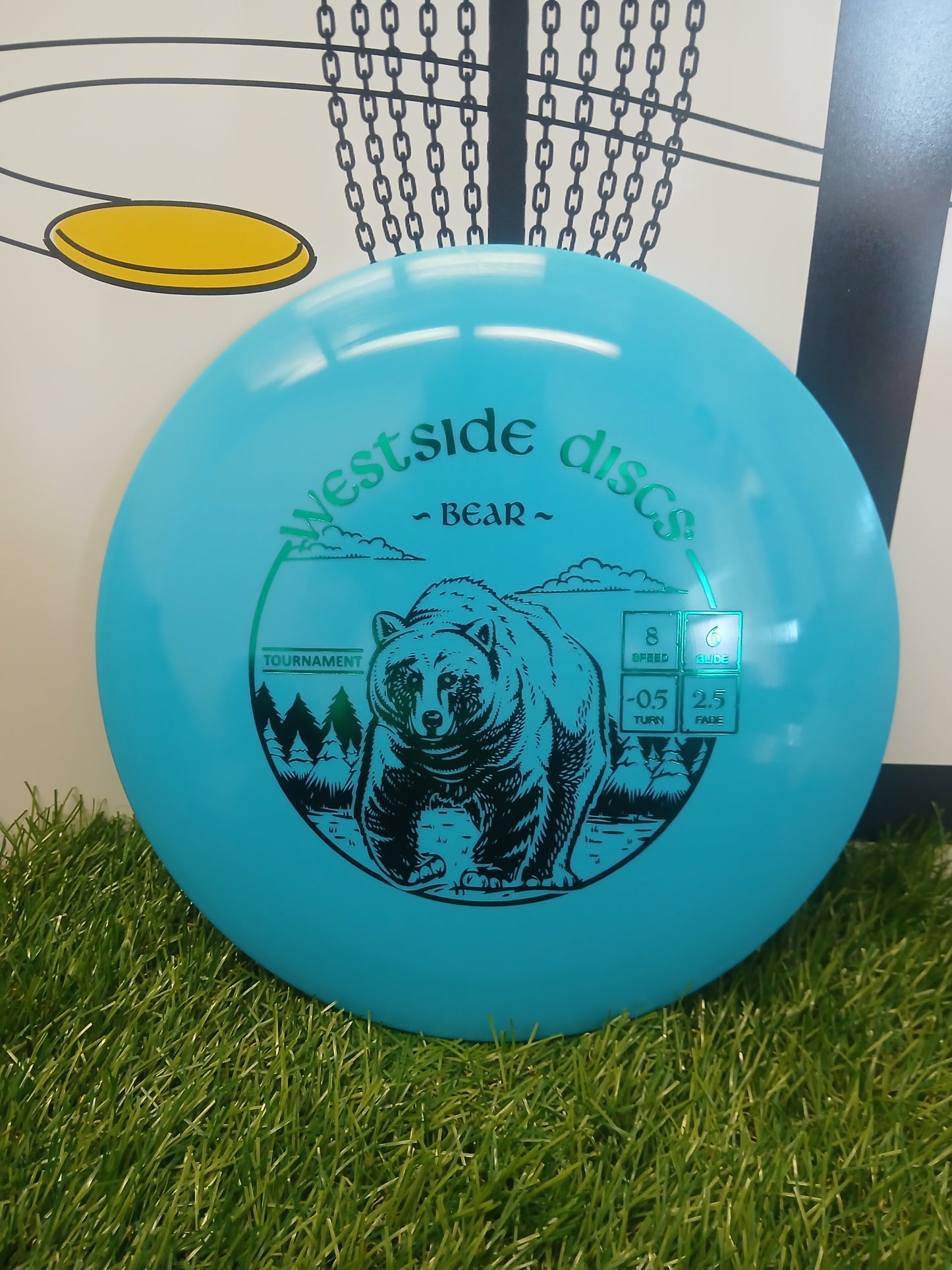 Westside Discs Bear disc golf disc with bear graphic on grass, ideal for tournament play