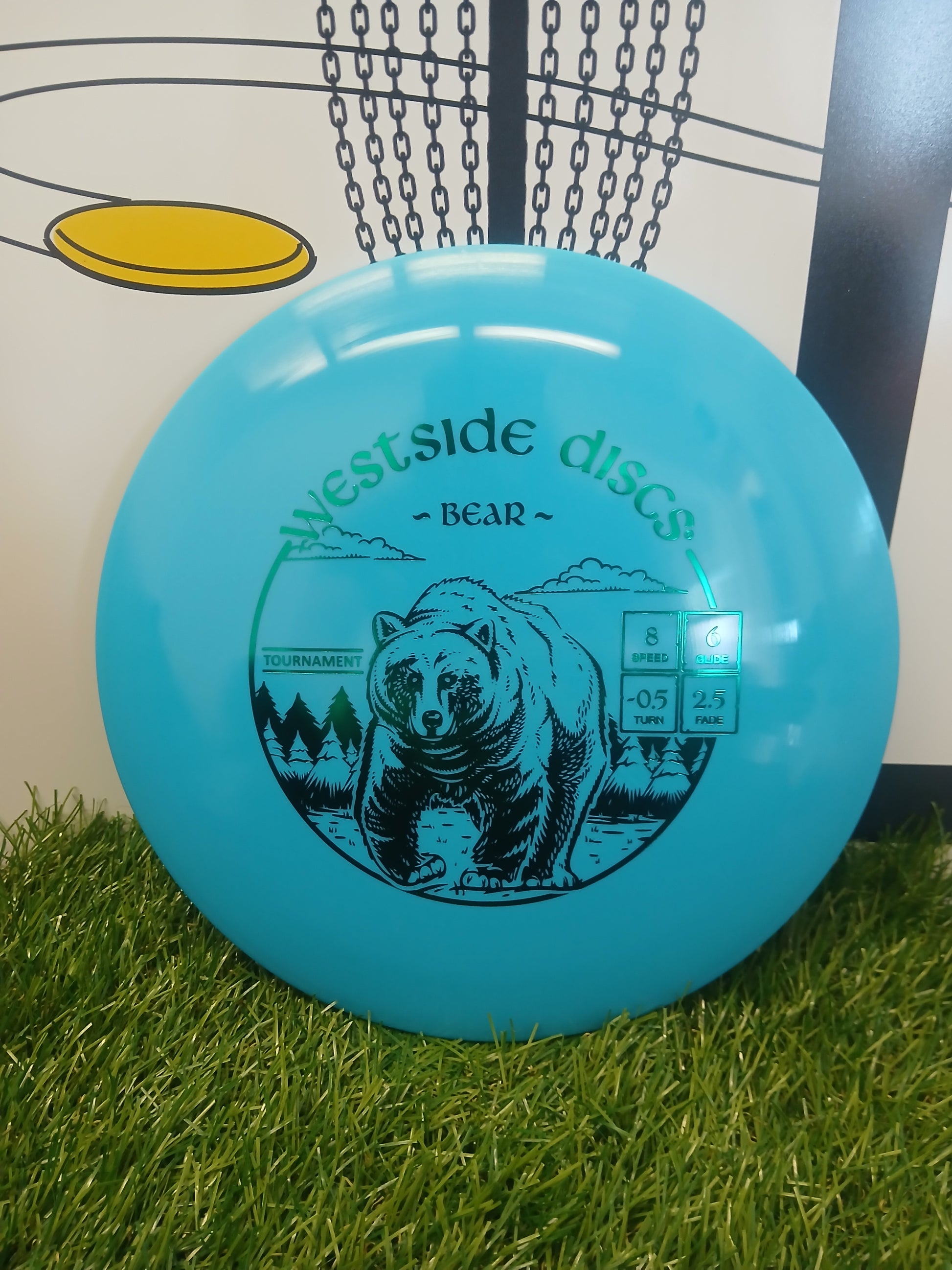 Westside Discs Bear disc golf disc with bear graphic on grass, ideal for tournament play
