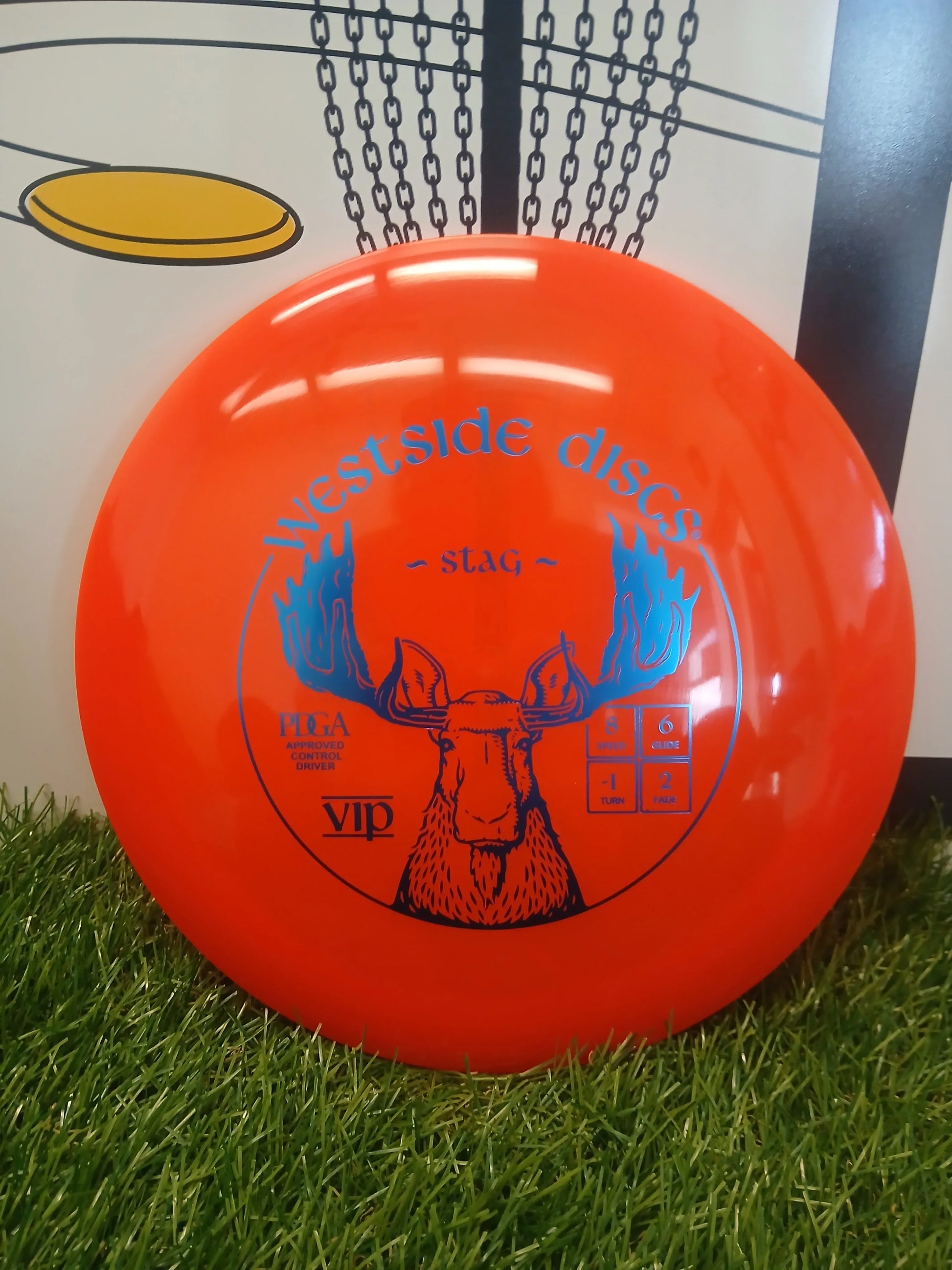 Bright orange Westside Discs Stag VIP disc golf driver on grass, PDGA approved with speed 8, glide 6, turn -1, fade 2