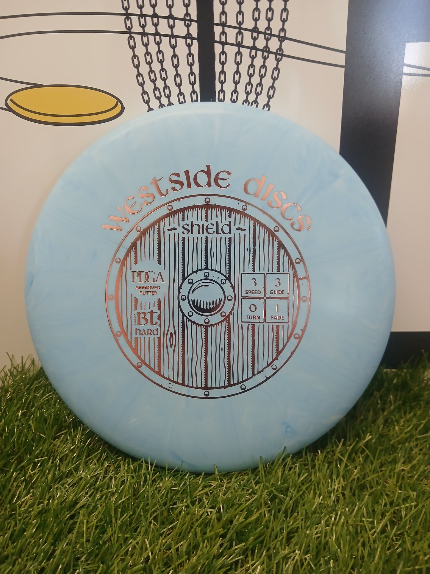 Westside Discs Shield BT Hard putter disc on grass, PDGA approved for disc golf