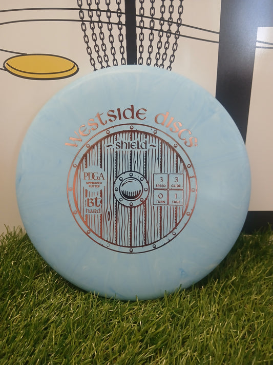 Westside Discs Shield BT Hard putter disc on grass, PDGA approved for disc golf