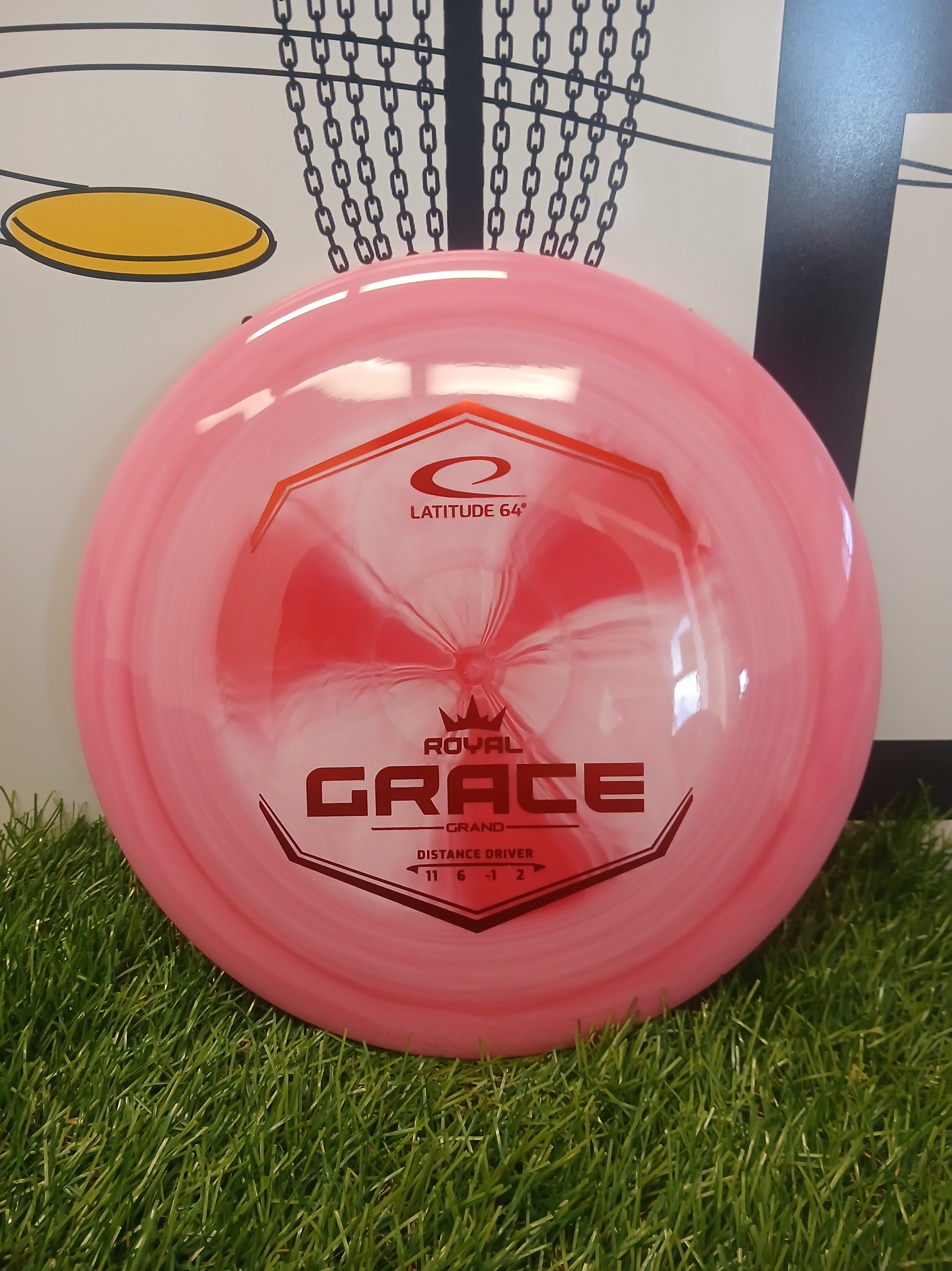 Pink Latitude 64 Royal Grace Grand distance driver disc golf disc on grass