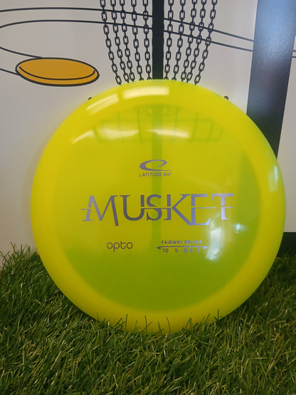 Bright yellow Latitude 64 Musket Opto fairway driver disc golf disc on grass