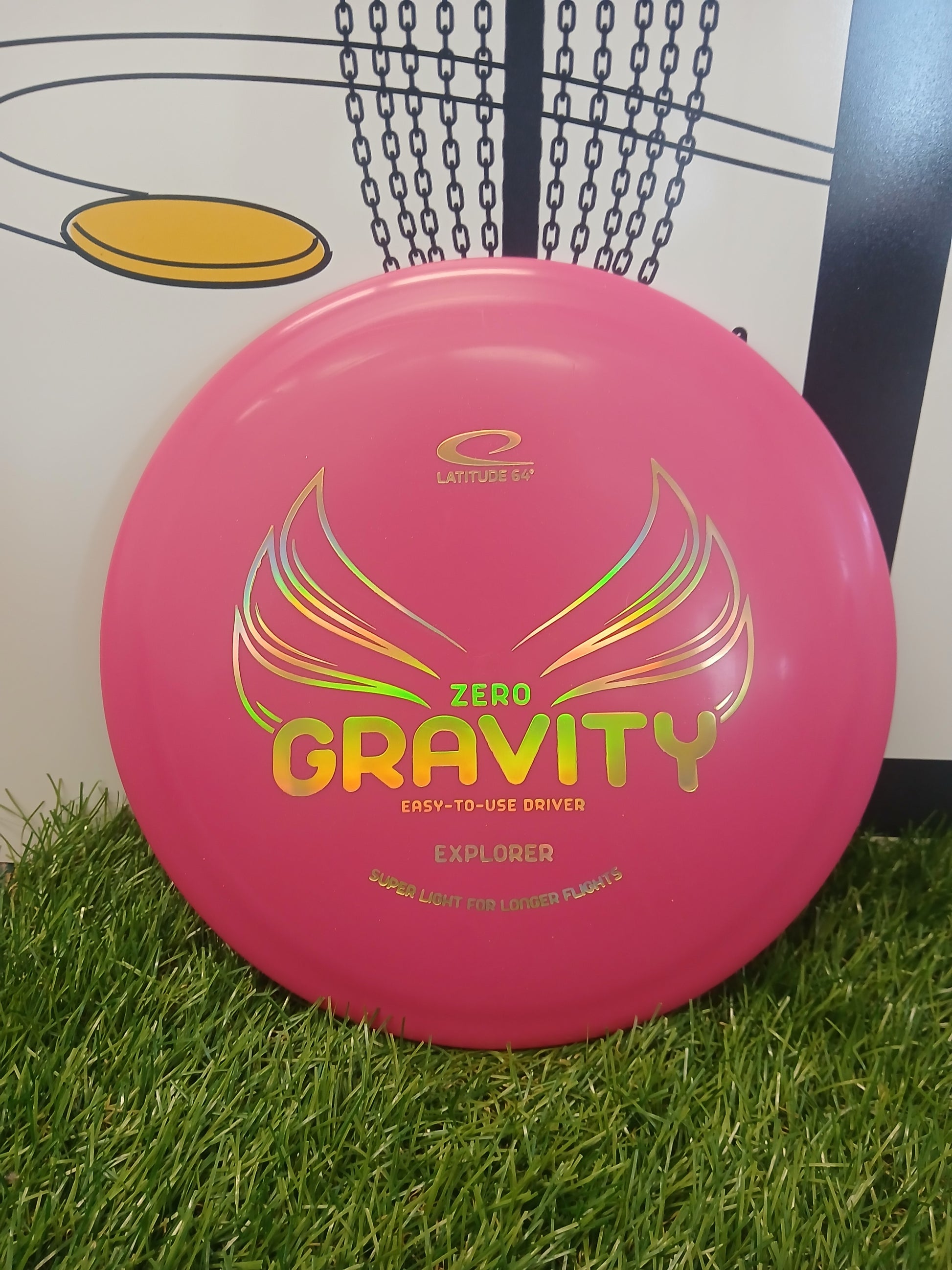 Pink Latitude 64 Zero Gravity Explorer disc golf driver on grass, easy-to-use for longer flights