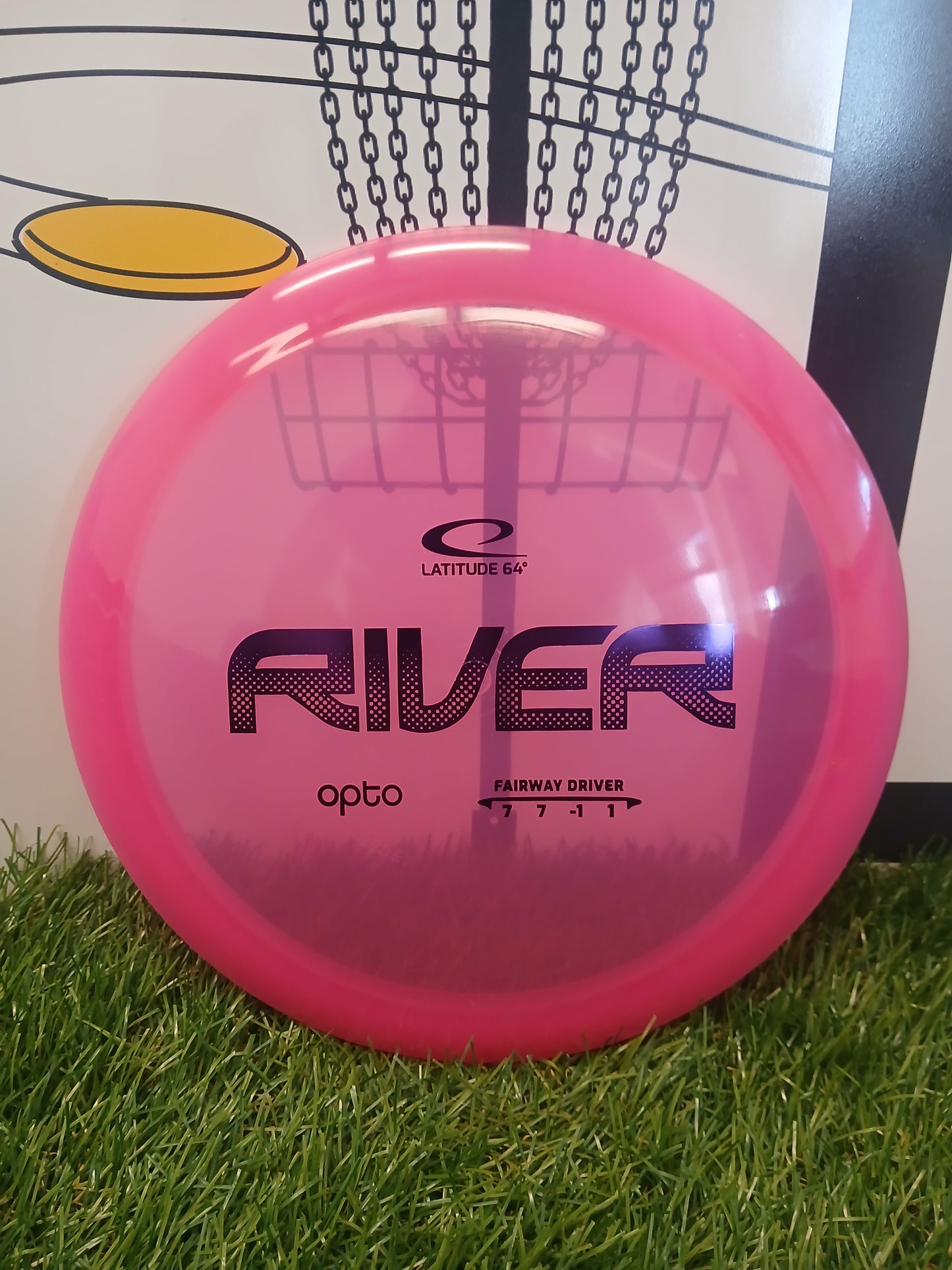 Pink Latitude 64 River Opto fairway driver disc golf disc on grass