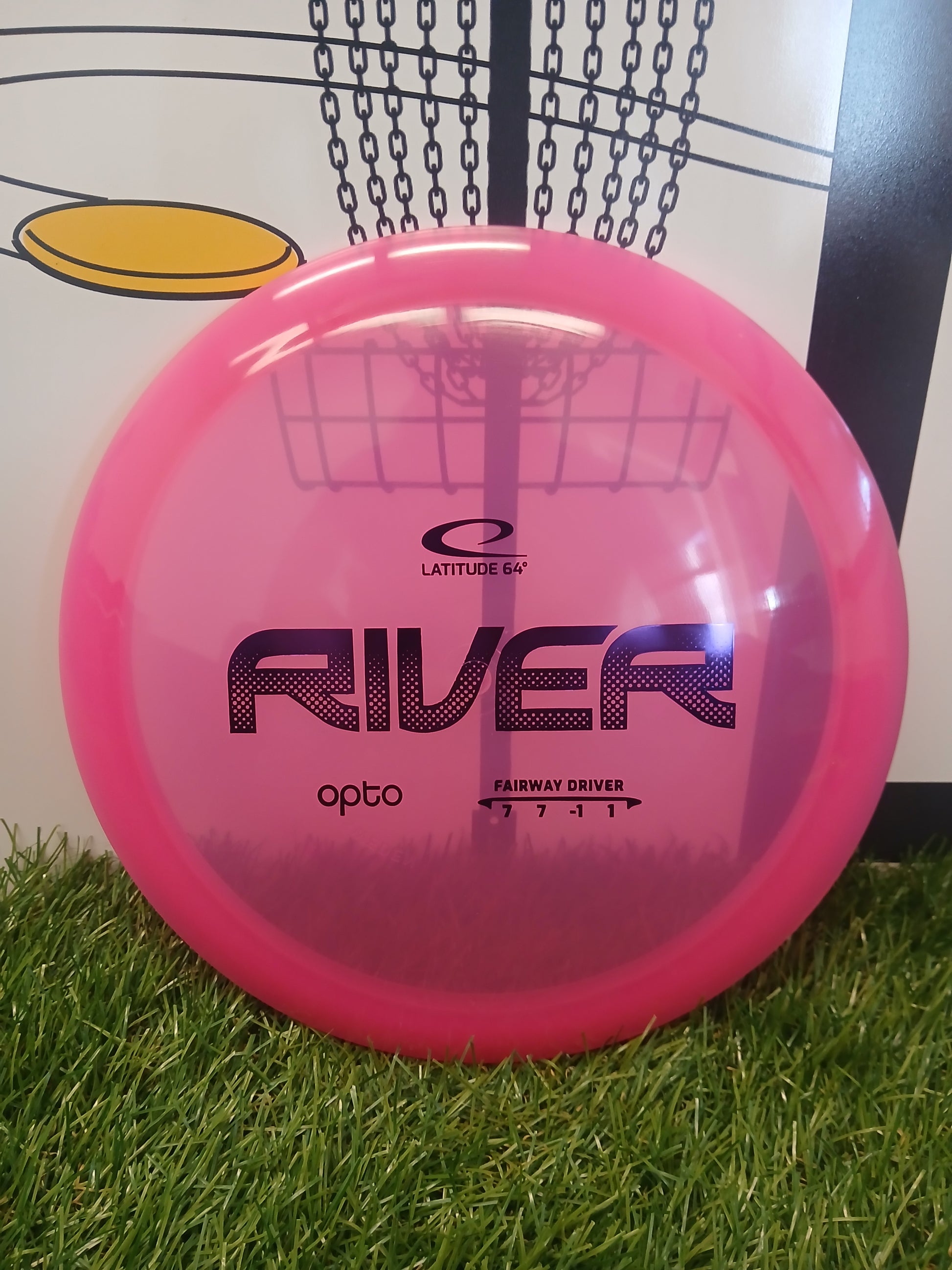 Pink Latitude 64 River Opto fairway driver disc golf disc on grass