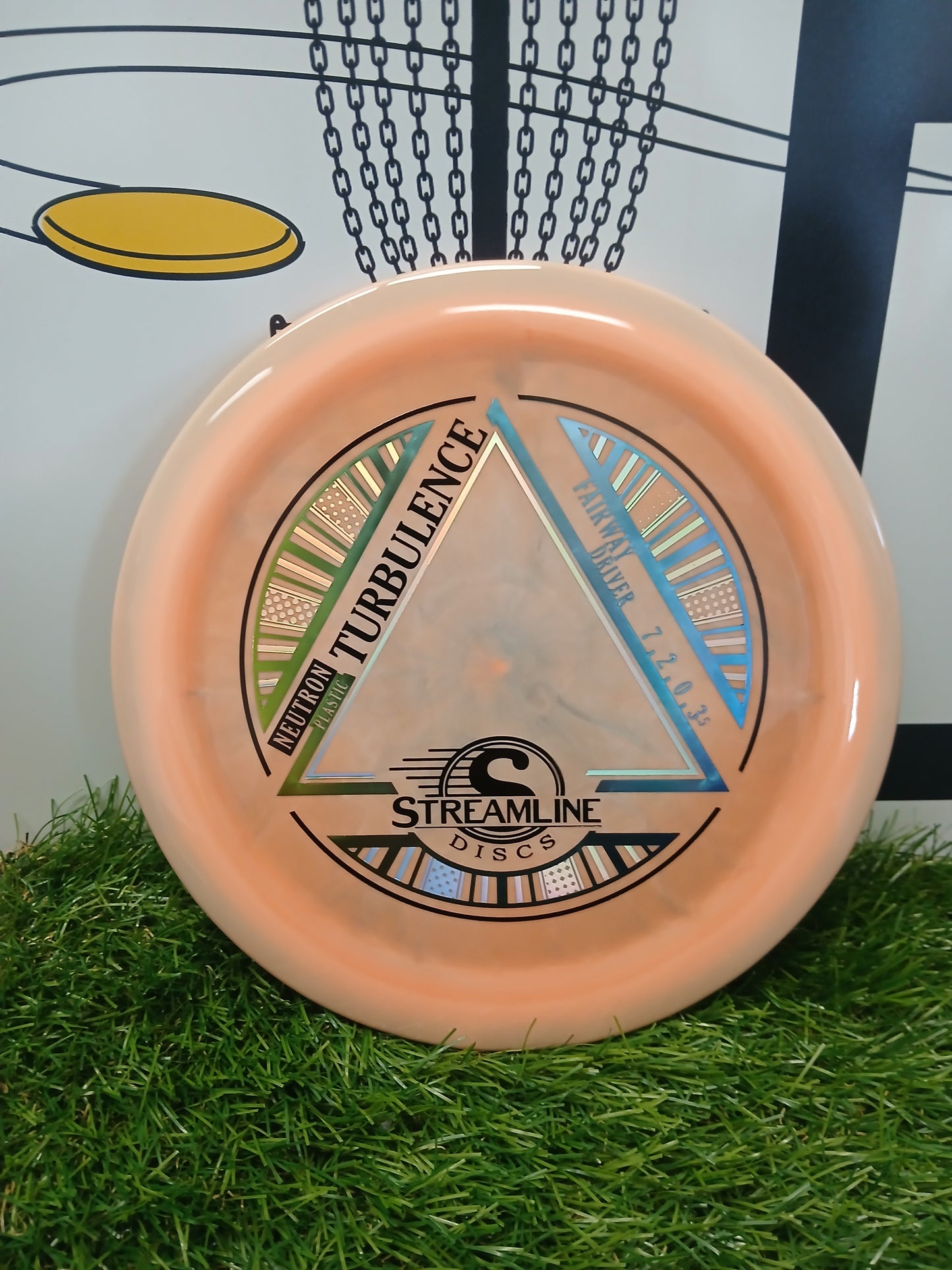 Neutron Turbulence fairway driver disc golf disc by Streamline Discs on grass