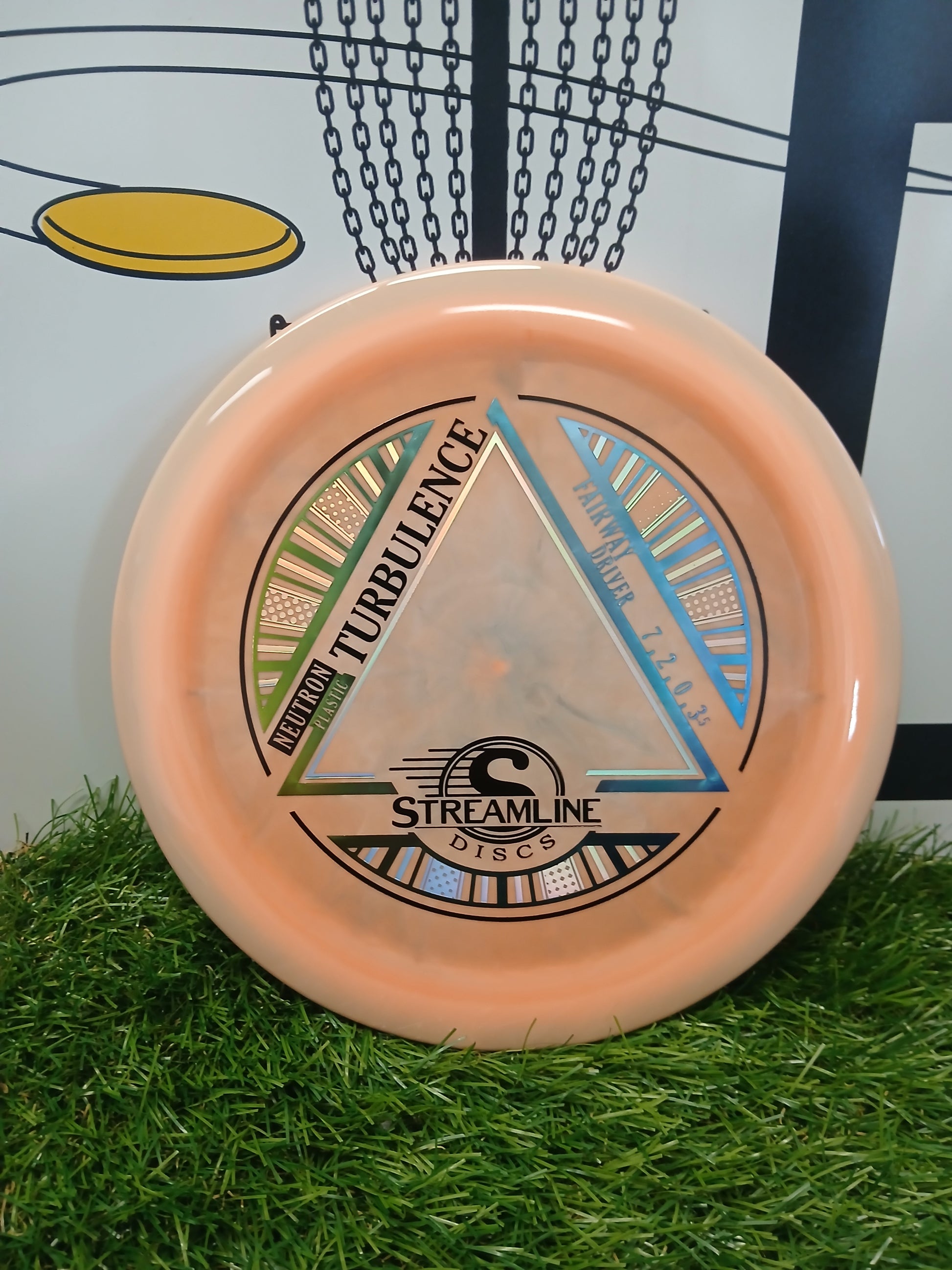 Neutron Turbulence fairway driver disc golf disc by Streamline Discs on grass
