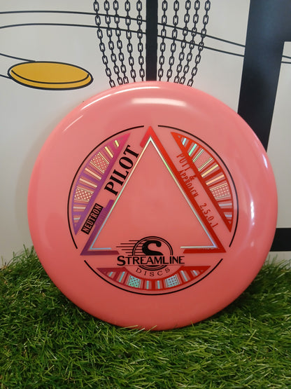 Pink Streamline Discs Pilot Neutron putter for disc golf on artificial grass