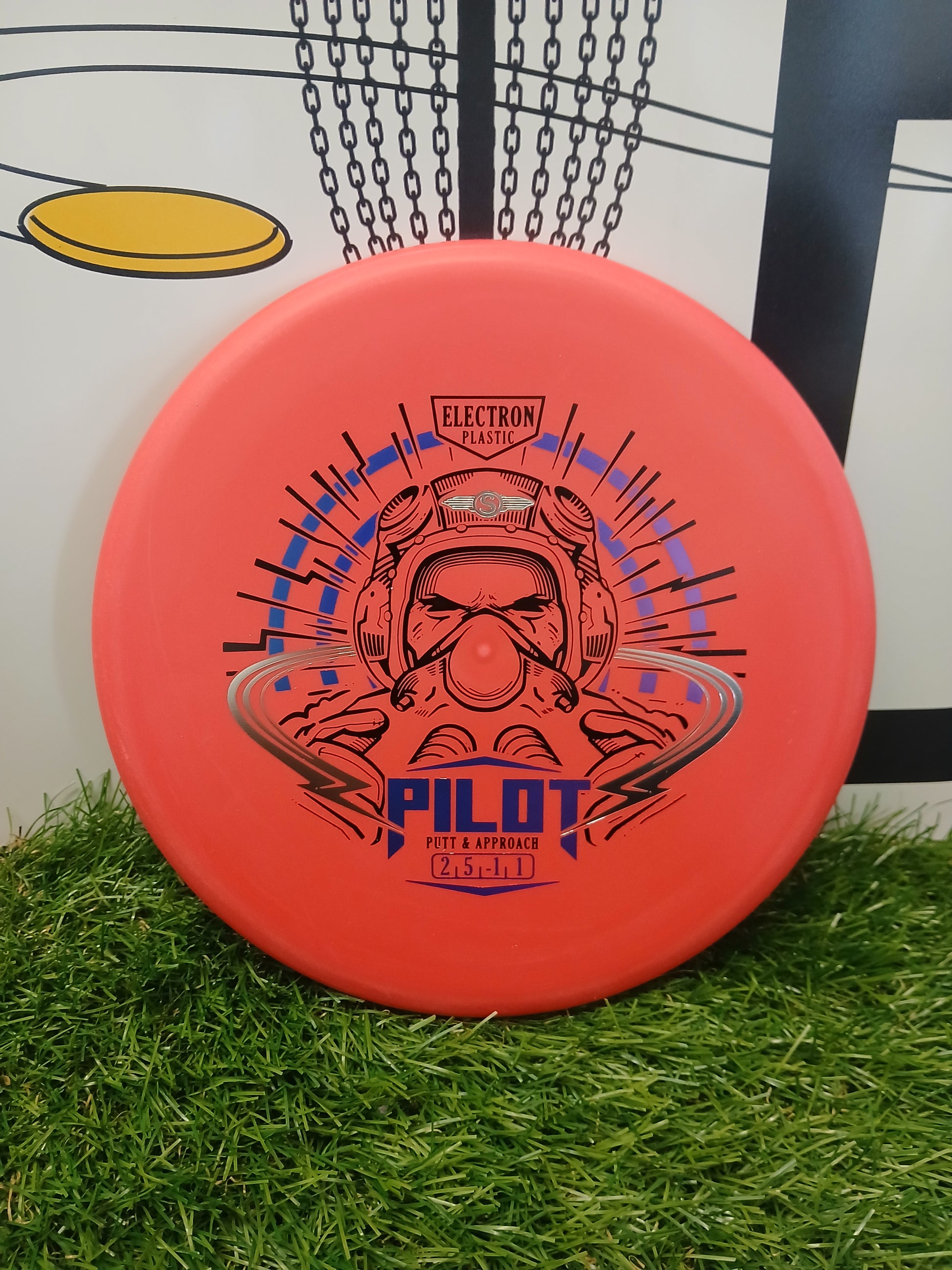 Orange Pilot putter disc golf disc in Electron plastic, designed for putt & approach shots, resting on grass.