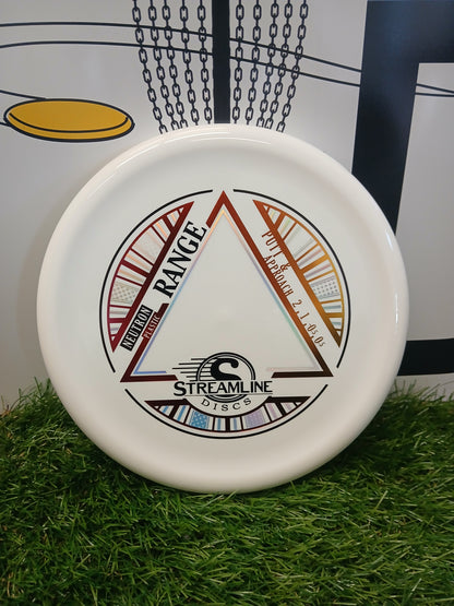 Streamline Discs Neutron Range putter & approach disc on grass, ideal for disc golf games and training.