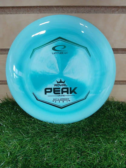 Latitude 64 Royal Peak Grand putter disc golf disc on grass, ideal for putt and approach shots.