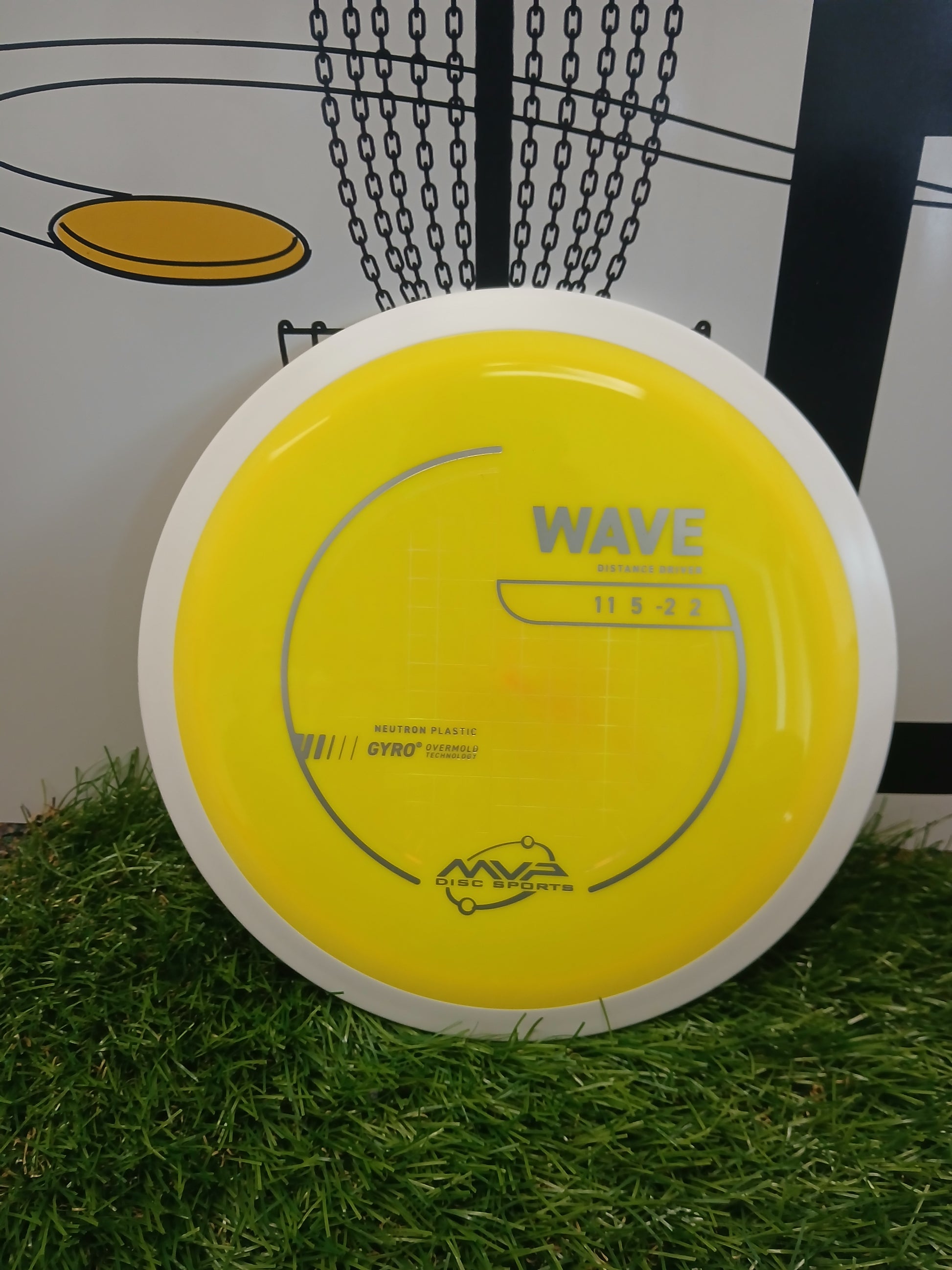 Yellow MVP Wave distance driver disc golf disc on grass, Neutron Plastic, Gyro Overmold tech