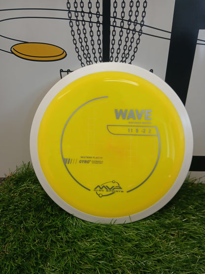 Yellow MVP Wave distance driver disc golf disc on grass, Neutron Plastic, Gyro Overmold tech