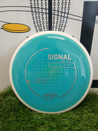 MVP Disc Sports Signal fairway driver disc golf disc on grass with basket background