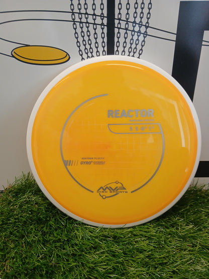 Yellow MVP Reactor midrange driver disc golf disc on grass, Neutron plastic with Gyro technology