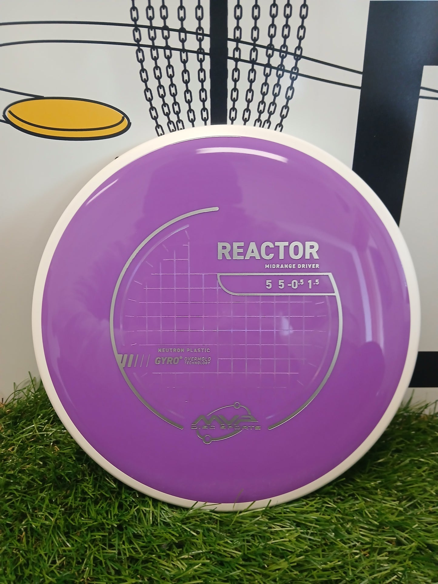 Purple MVP Disc Sports Reactor midrange driver disc on grass, featuring Neutron plastic and Gyro technology.