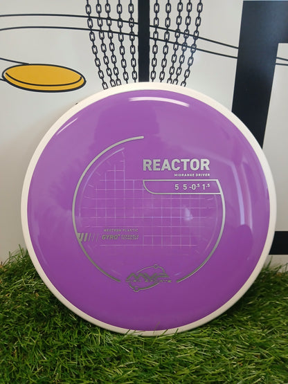 Purple MVP Disc Sports Reactor midrange driver disc on grass, featuring Neutron plastic and Gyro technology.