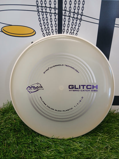 MVP Disc Sports Glitch Hybrid Catch Disc on grass, featuring Gyro Overmold Technology and Eclipse glow plastic.