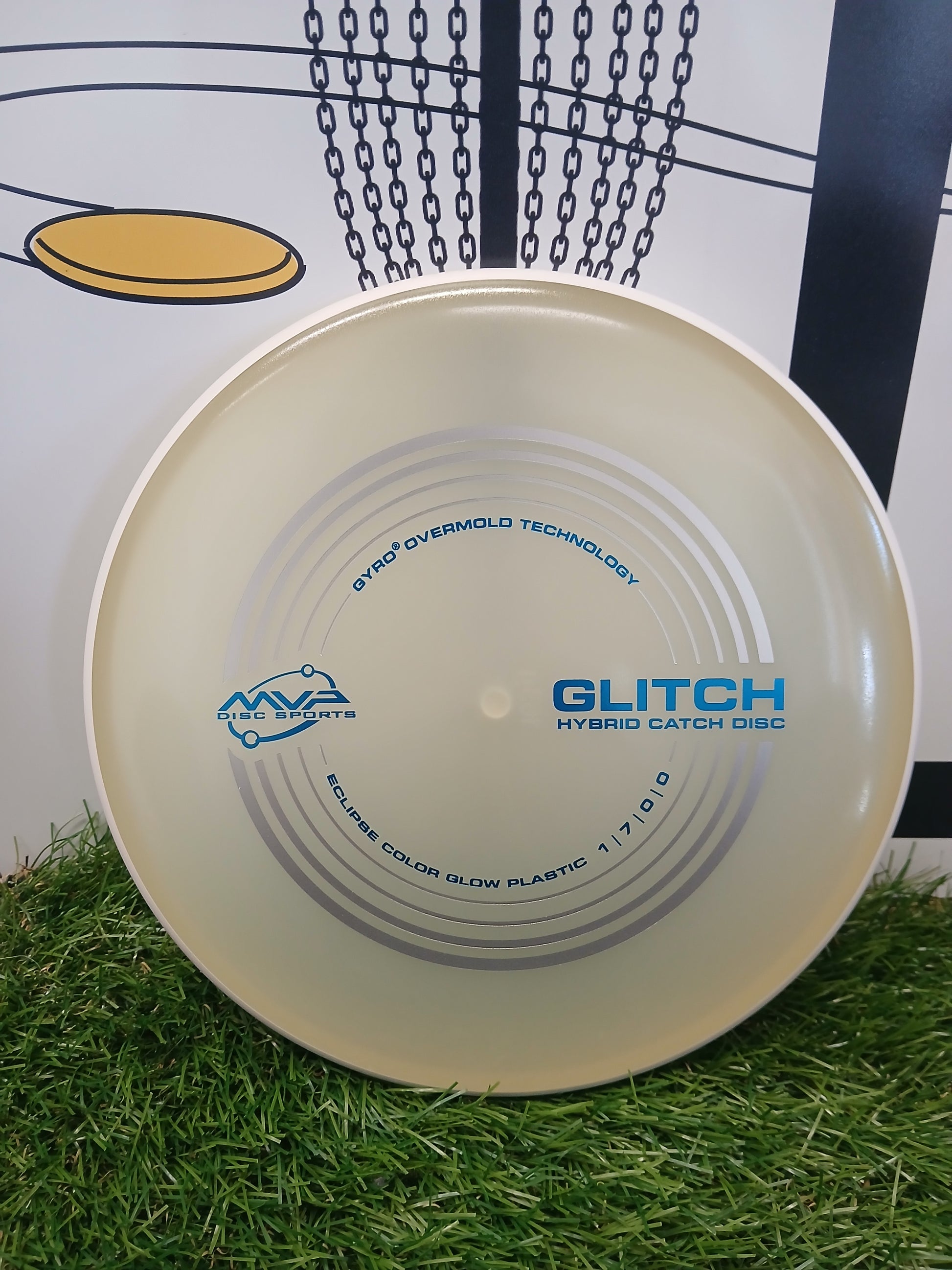 MVP Disc Sports Glitch Hybrid Catch Disc on grass, featuring Gyro Overmold Technology and Eclipse glow plastic.