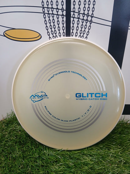 MVP Disc Sports Glitch Hybrid Catch Disc on grass, featuring Gyro Overmold Technology and Eclipse glow plastic.