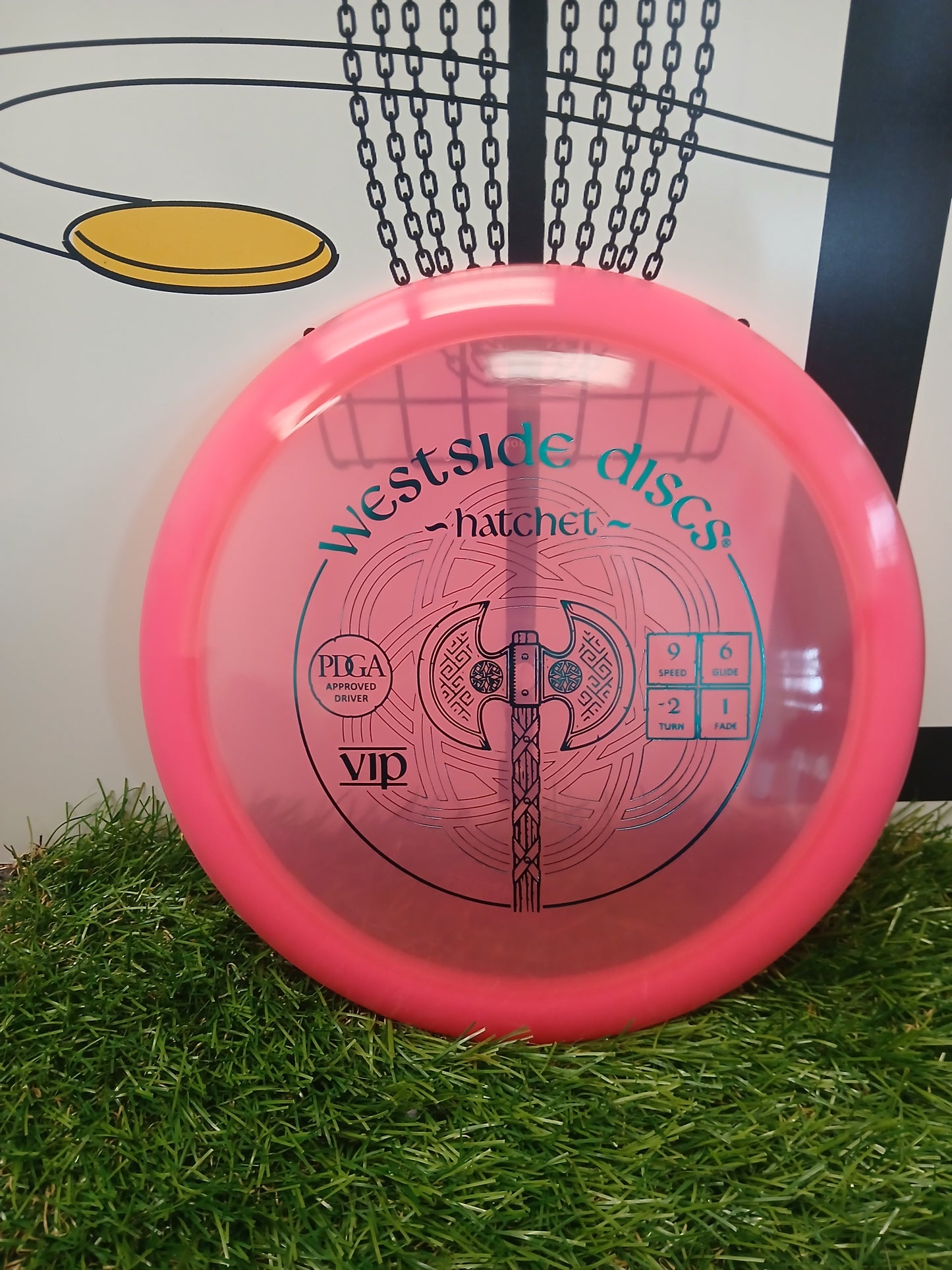 Pink Westside Discs Hatchet VIP driver disc golf disc on grass, PDGA approved with speed 9