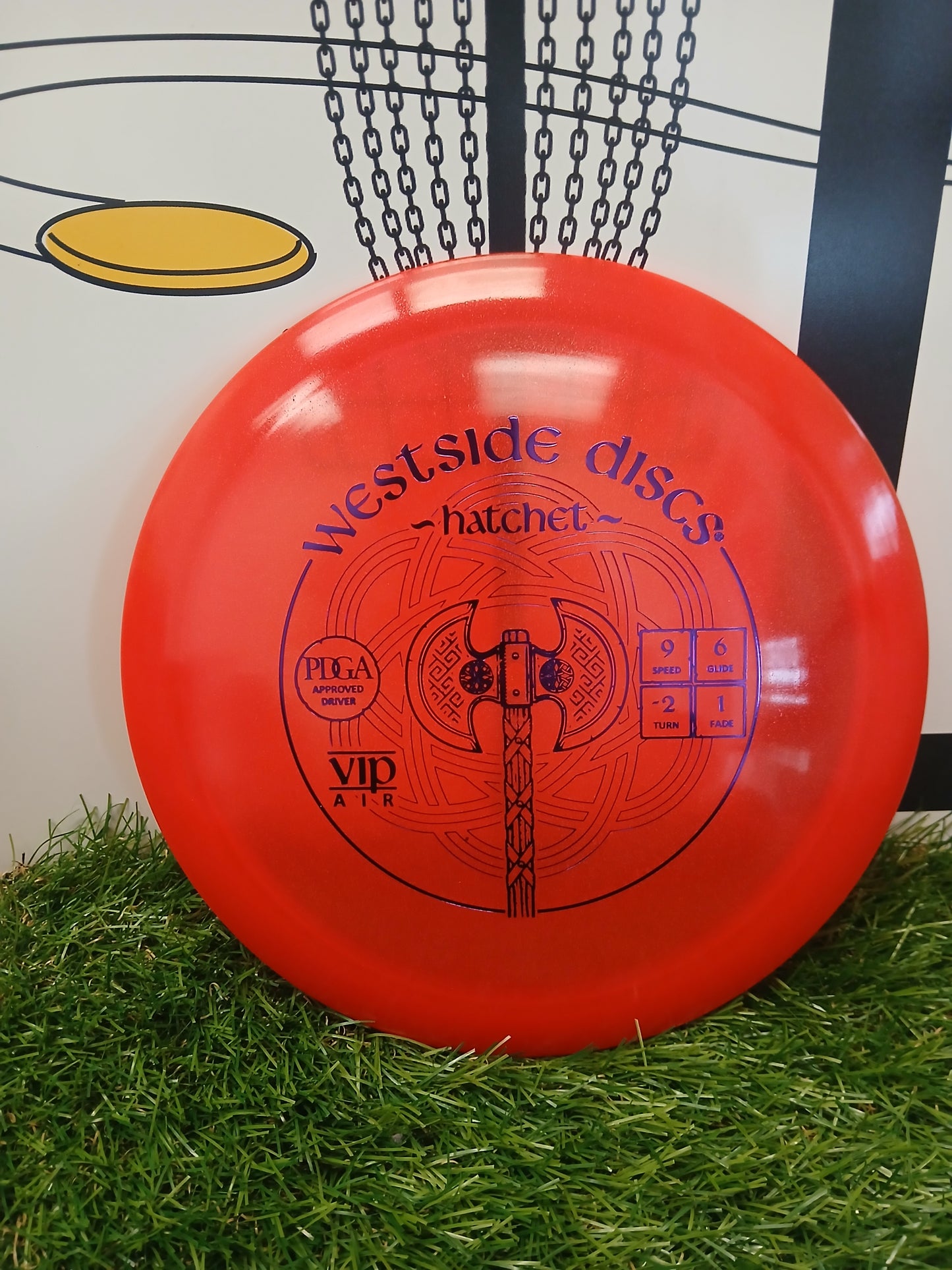Westside Discs Hatchet VIP Air disc golf driver on grass, PDGA approved with flight numbers 9/6/-2/1
